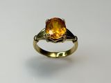 a close up of a gold ring with a citrine stone