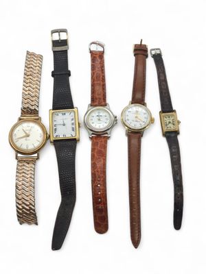 several different types of watches are lined up on a white surface