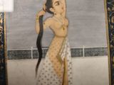 a painting of a woman with long hair on display