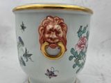 a vase with a lion head on it on a table