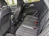 the back seats of a silver car with black seats in it