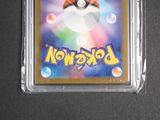 the pokemon card is in a clear plastic holder on a black surface