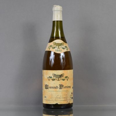 an old bottle of wine sitting on top of a table