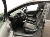 the interior of a car with the door open and the driver ' s seat down