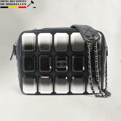 a black and white bag with a chain on it