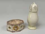 a white salt and pepper shaker sitting next to each other