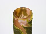 a vase that has a green and yellow design on it
