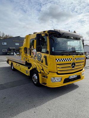 a yellow truck that is parked in a parking lot