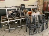 many chairs and tables in a restaurant with a lot of chairs
