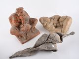 three pieces of pottery sitting on a white surface