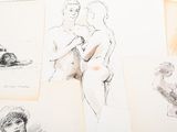 several sketches of a man and a woman are on a table