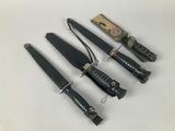 several knives are lined up in a row on a white surface