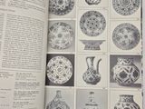 a book with pictures of vases in it on a table