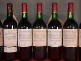 several bottles of wine are lined up on a table