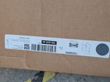 a cardboard box with a sticker on it sitting on the ground