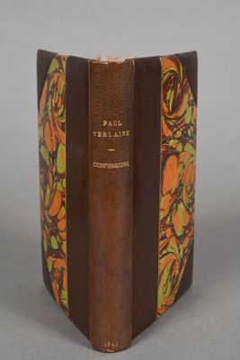 an old book with a brown cover sitting on top of a table