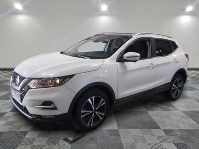 the white nissan suv is parked in a large room