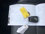 a book with a car key and a yellow tag on it
