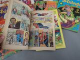 a person holding a comic book open on a table