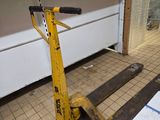 a yellow hand truck sitting on the floor in a kitchen