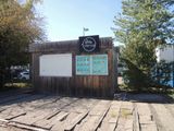 a small wooden building with a sign on the side of it