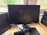 a computer desk with two monitors and a keyboard on it