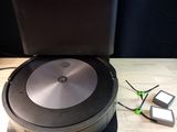a black and silver robot sitting on top of a wooden table