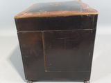 an old wooden box with a black top and a brown door