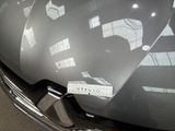 a sticker on the hood of a car that is parked in a parking lot