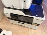 a printer sitting on top of a printer on the floor