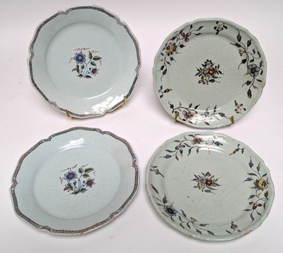three plates with floral designs on them sitting on a white surface