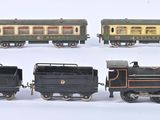 several toy trains are lined up in a row on a white surface