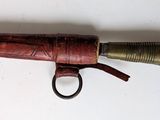 a small knife that is hanging on a wall