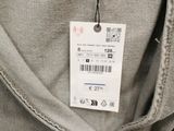 the back of a pair of grey pants with a tag on it