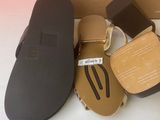 the box is open and there are three pairs of sandals in it