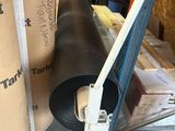 a roll of tape on the floor next to a roll of cardboard