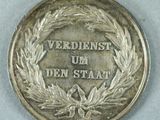 a close up of a medal with a ribbon around it