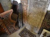 many pieces of carved wood sitting on the floor