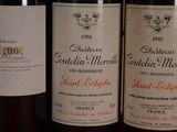 several bottles of wine are lined up on a table