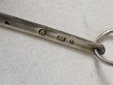 a pair of scissors sitting on a table with a keychain