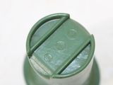 a close up of a green bottle with a lid