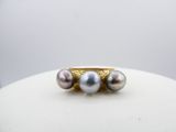 an image of a gold ring with three pearls on top of it