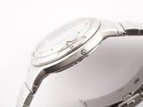 a close up of a watch on a white surface
