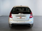 a picture of a white car parked in a garage