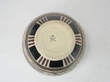 a black and white plate with a design on it