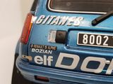 a close up of a blue car with a sticker on it