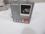 a polaroid camera sitting on a table next to a printer
