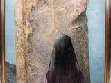 painting of a woman standing in front of a large rock with a cross on it