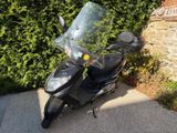 a scooter that is parked in front of a wall
