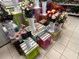 many vases of flowers on the table in the store
